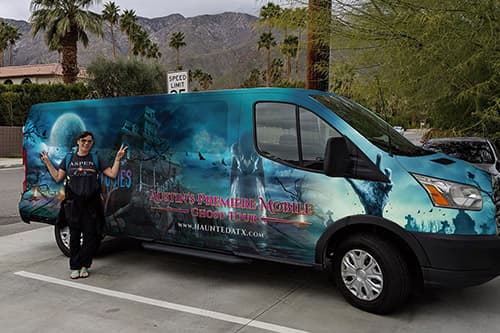 Customer posing in front of Haunted ATX Van