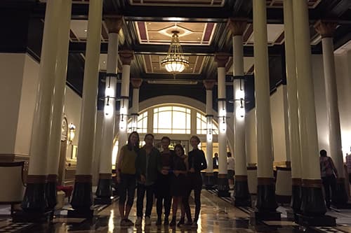 Five young customers standing in a haunted hotel's lobby