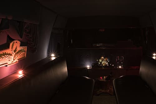 Inside of the hearse with complimentary drinks and BYOB bottle of bubbly